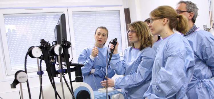 Group of trainees with one person using simulator image