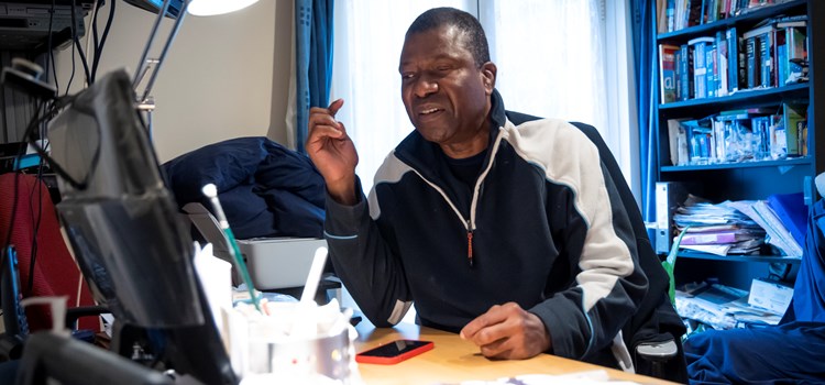 A New National Induction Framework for Adult Social Care image A man sat at a desk, in front of a computer image